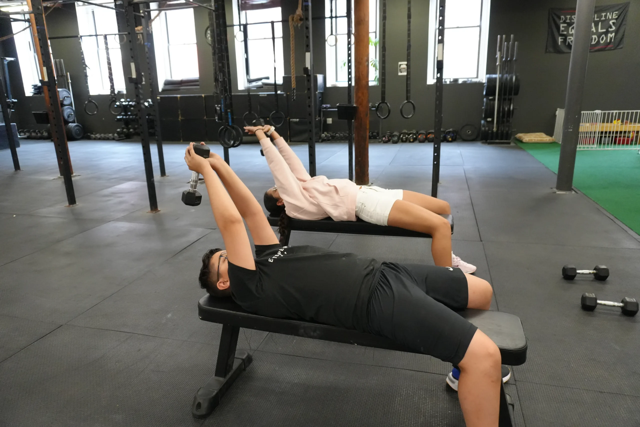 Example of a Gym where an owner is trying to write content for personal training as visualized in the image with two people working out.